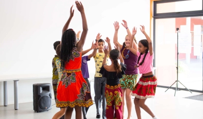  Students paint with brushes in a school art classroom.