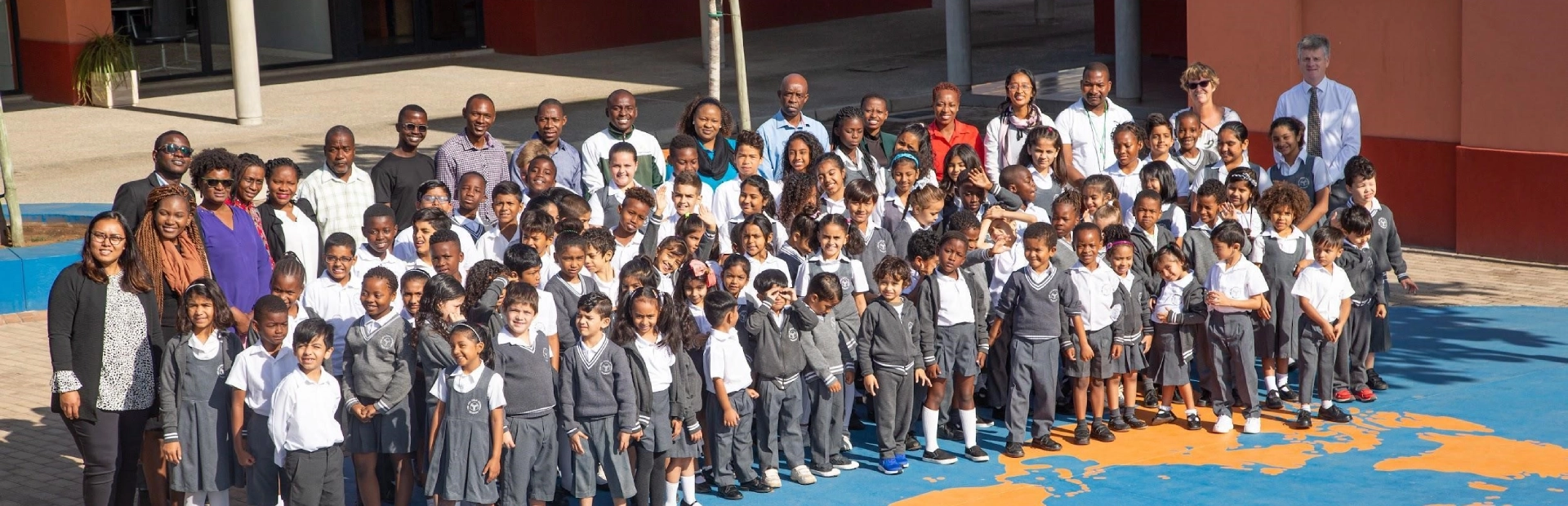  AKA Maputo students and staff standing outside together.
