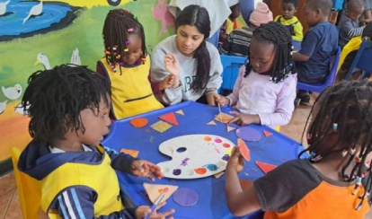 Mahek and students engaged in a group activity.