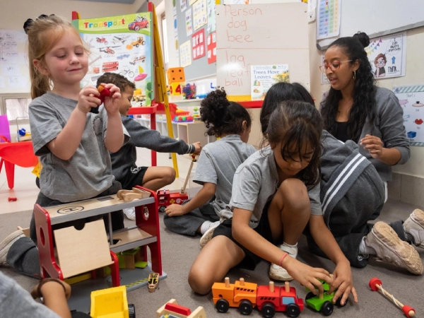 Early Years Programme students with their teacher inside their classroom.