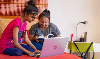 Two students spending time together in their residential room at AKA Maputo.