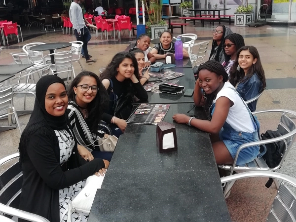 Two students at AKA Dhaka focus on drawing and colouring during an art class.