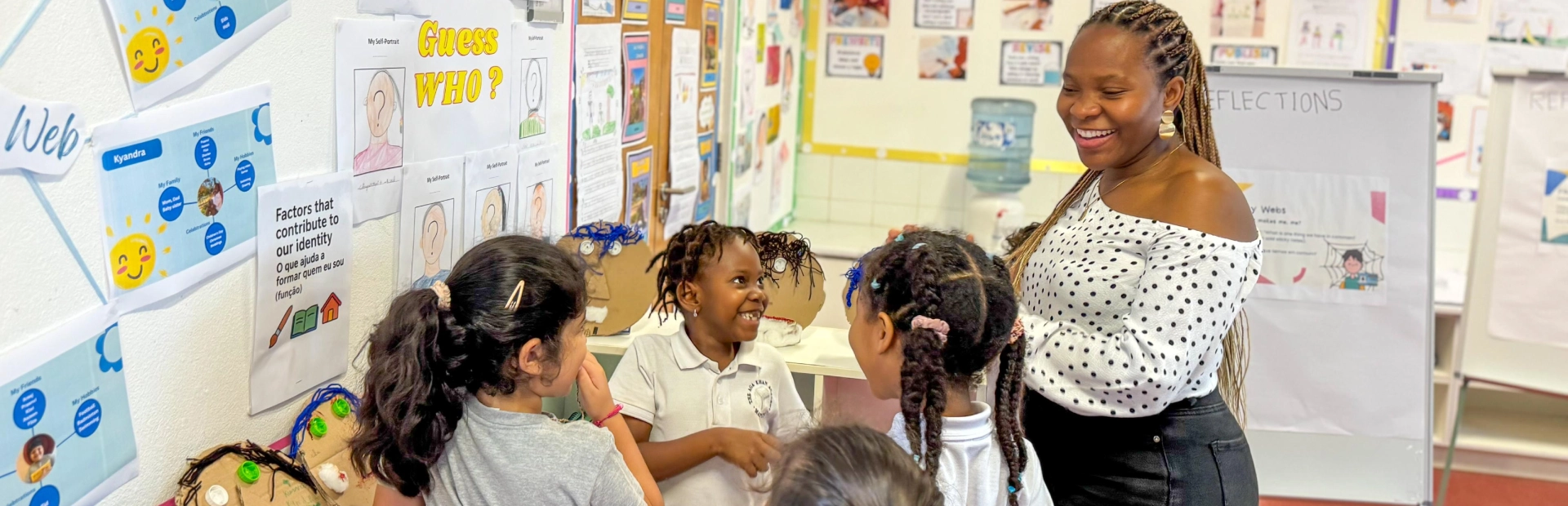 Students in the classroom actively participating in a lesson with their teacher.