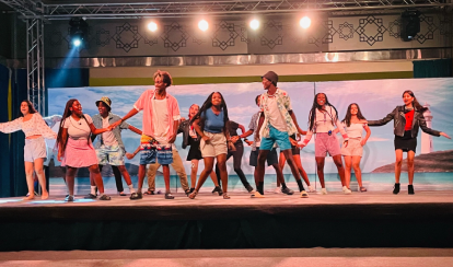 Students performing on a stage.