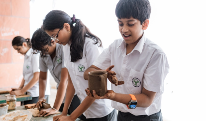 Students participating in a pottery activity.