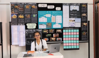Grade 10 student Rodoshi Tahrin presenting her bicycle-powered generator project at the personal project exhibition.
