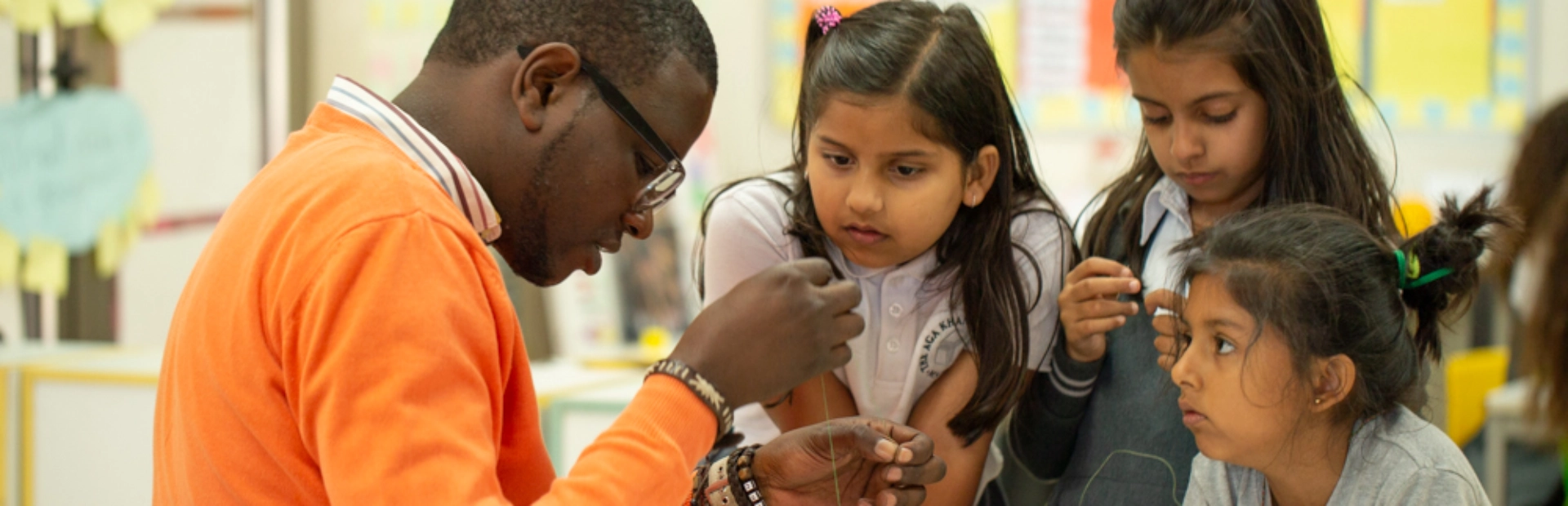 Students join their teacher for a simple and engaging string activity.