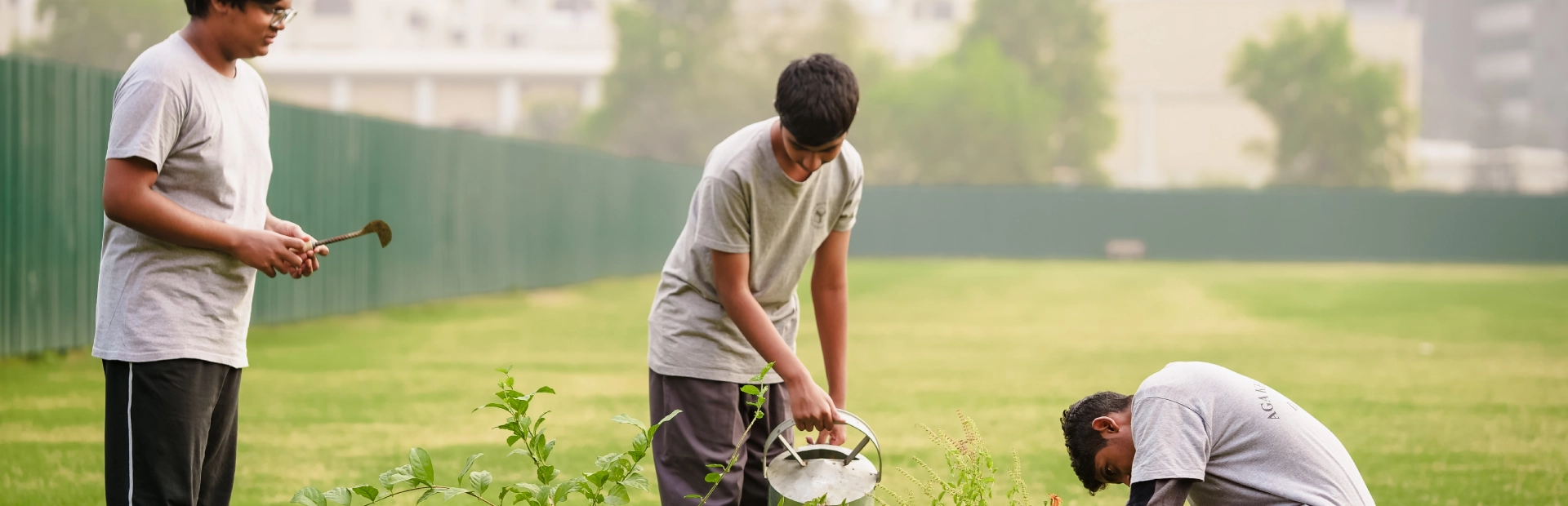 Students at AKA Dhaka tend to the on-campus plants, reflecting environmental stewardship and mindfulness.
