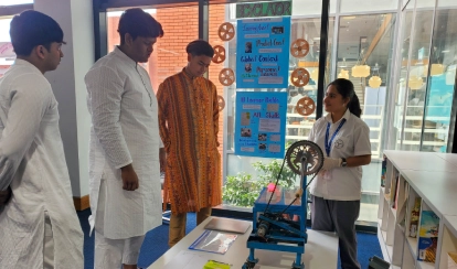 Grade 10 student Rodoshi Tahrin presenting her bicycle-powered generator project at the personal project exhibition.