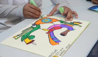 Student colours a bright abstract drawing