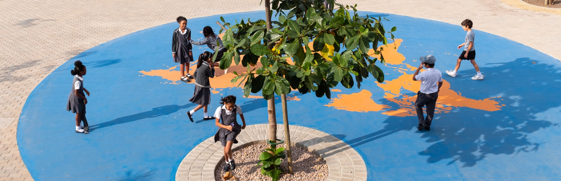  Students enjoying their break, smiling and interacting in the junior school campus.